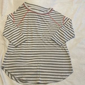 Maurice’s striped baseball style shirt with 3/4 sleeves and orange stitching.